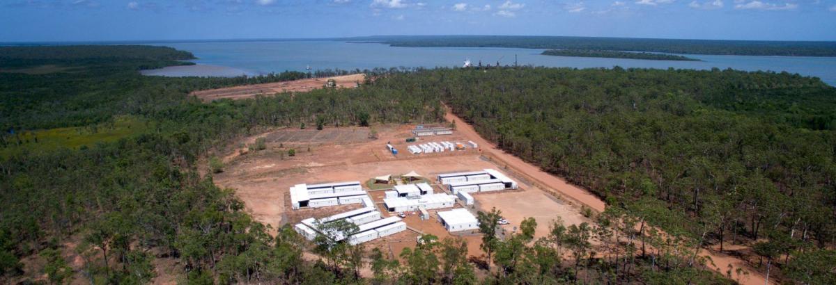 Aerial view of Bathurst Island township showing homes, roads and coastal landscape